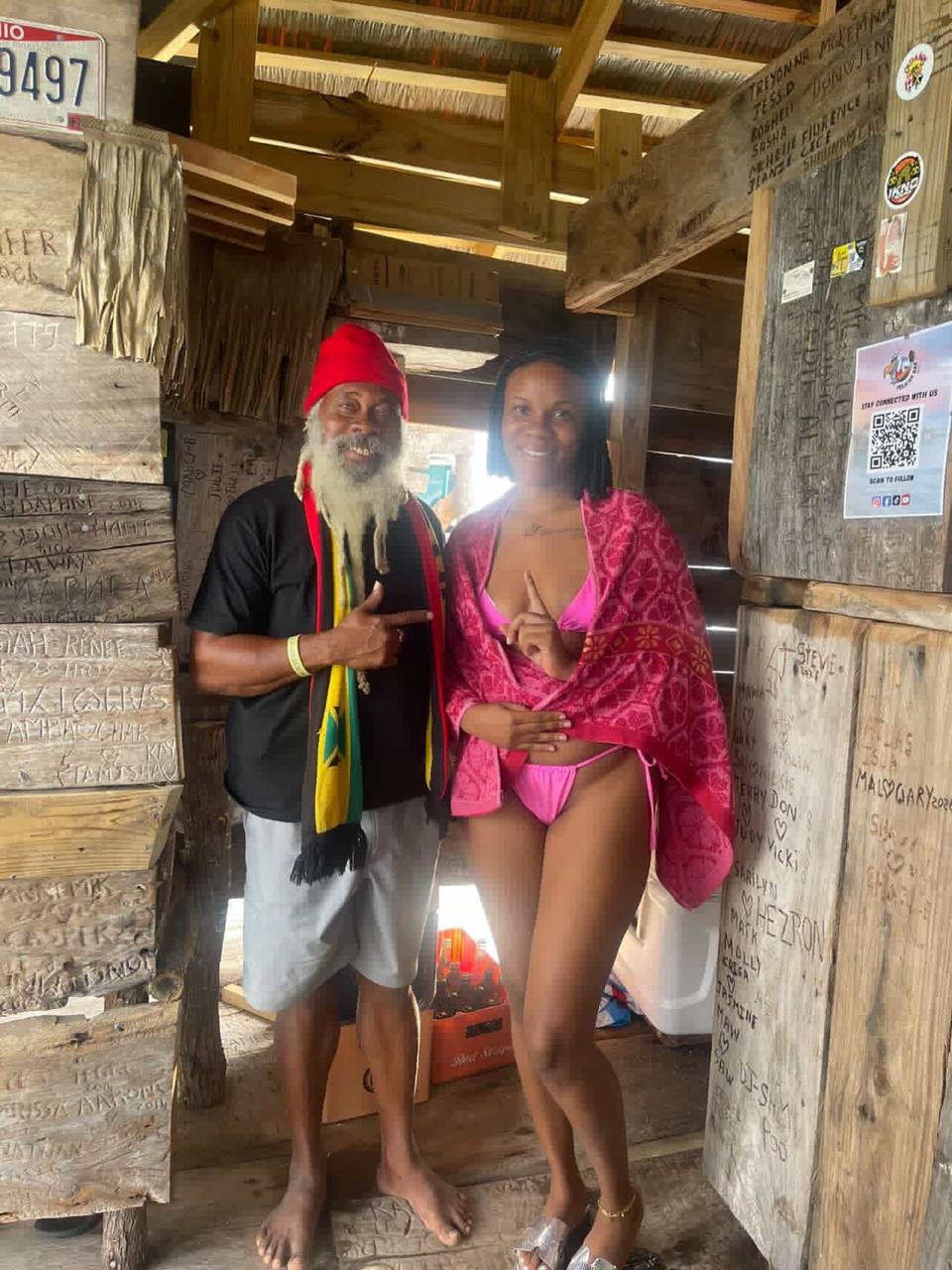 Guest posing with the host inside the bar