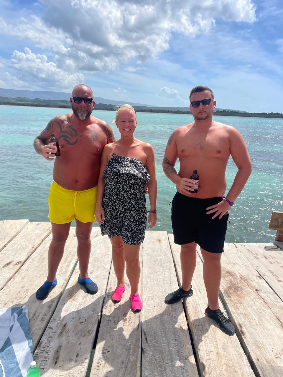 Friends on the deck with turquoise water behind