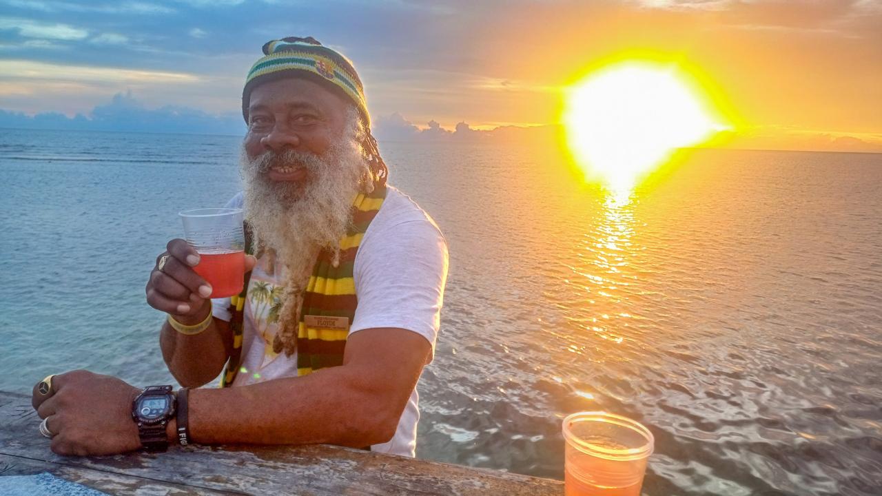 Guest enjoying a drink at sunset on Pelican Bar